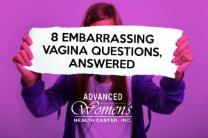 Woman holding banner. 8 Embarrassing Vagina Questions, Answered
